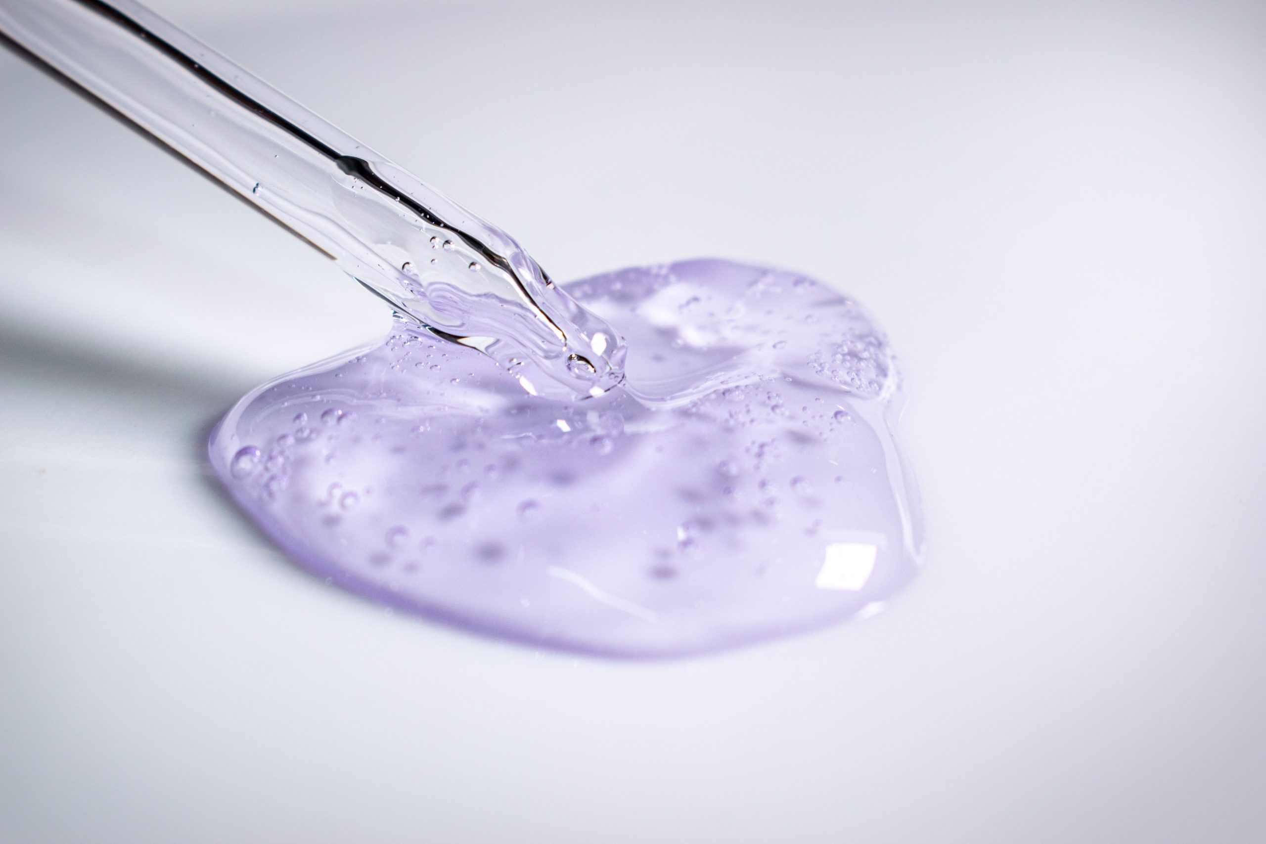 Cosmetic formulation ingredient being measured with a pipette, illustrating the batch-level precision tracked by KnarrTek's cosmetic manufacturing software during blending.